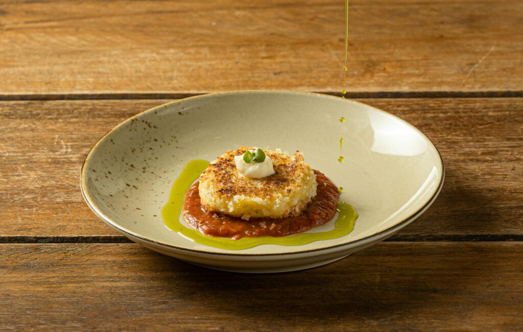 Frittella di patate e taleggio su letto di sugo al pomodoro